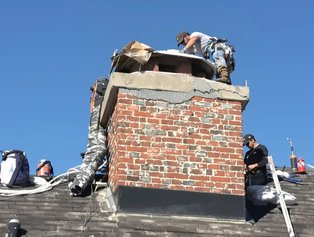 Smithfield Chimney Sweep installing a custom chimney crown in Smithfield, RI