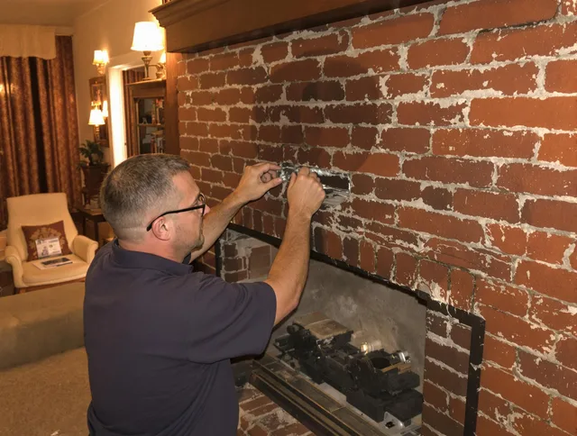Smithfield Chimney Sweep expert fixing a fireplace in Smithfield, RI